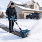 Man clearing a snowy driveway with the FrostSweeper cordless snow sweeper